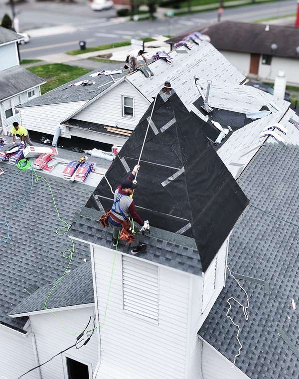 Crew working on a steep residential roof