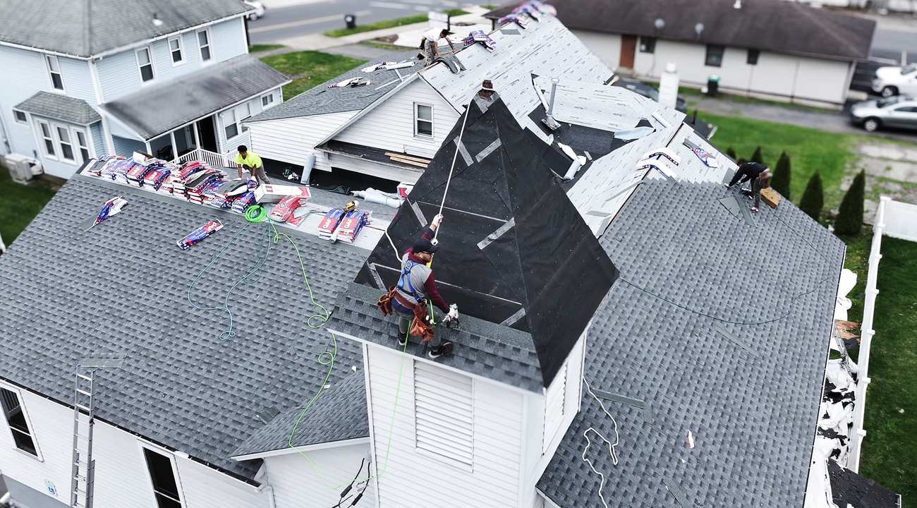 Condition One crew working on a steep residential roof section during a repair