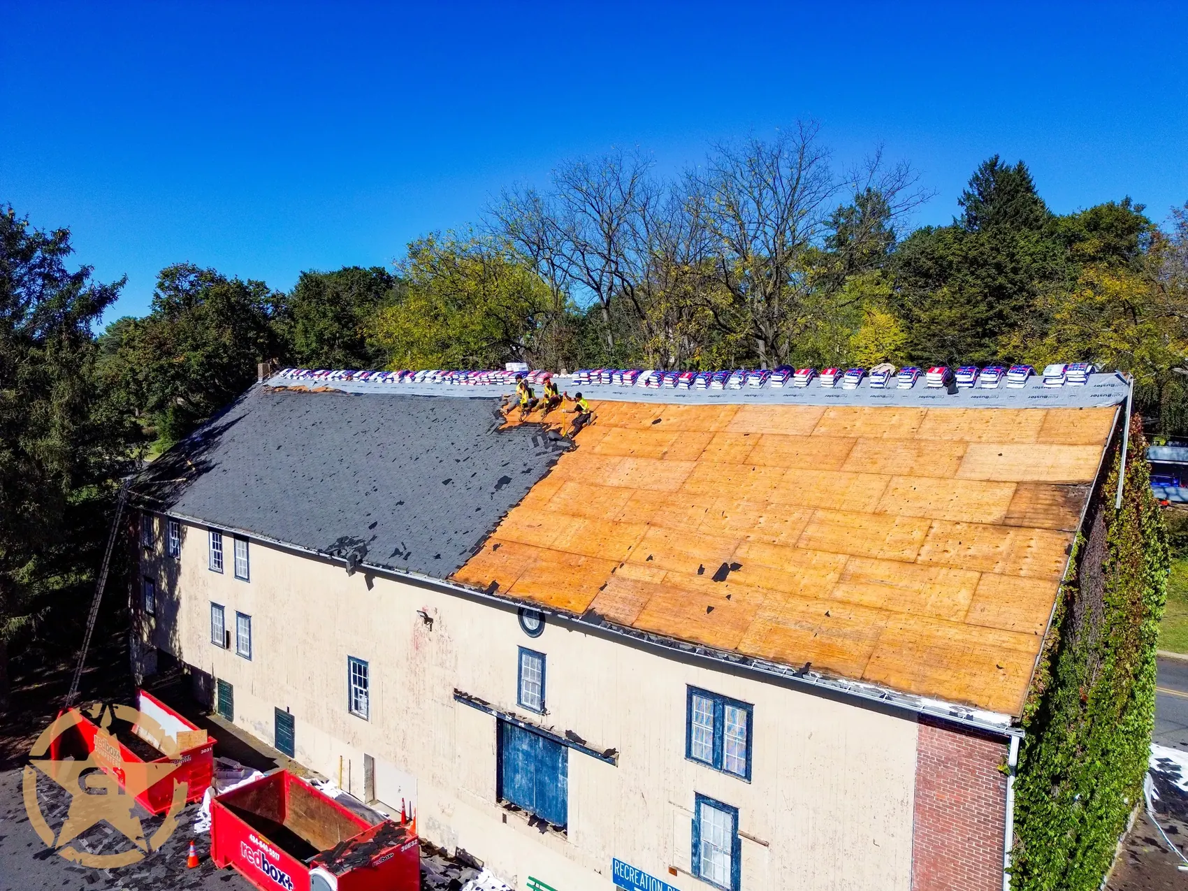 Tear-off in progress on an Allentown row home roof showing the wood decking underneath