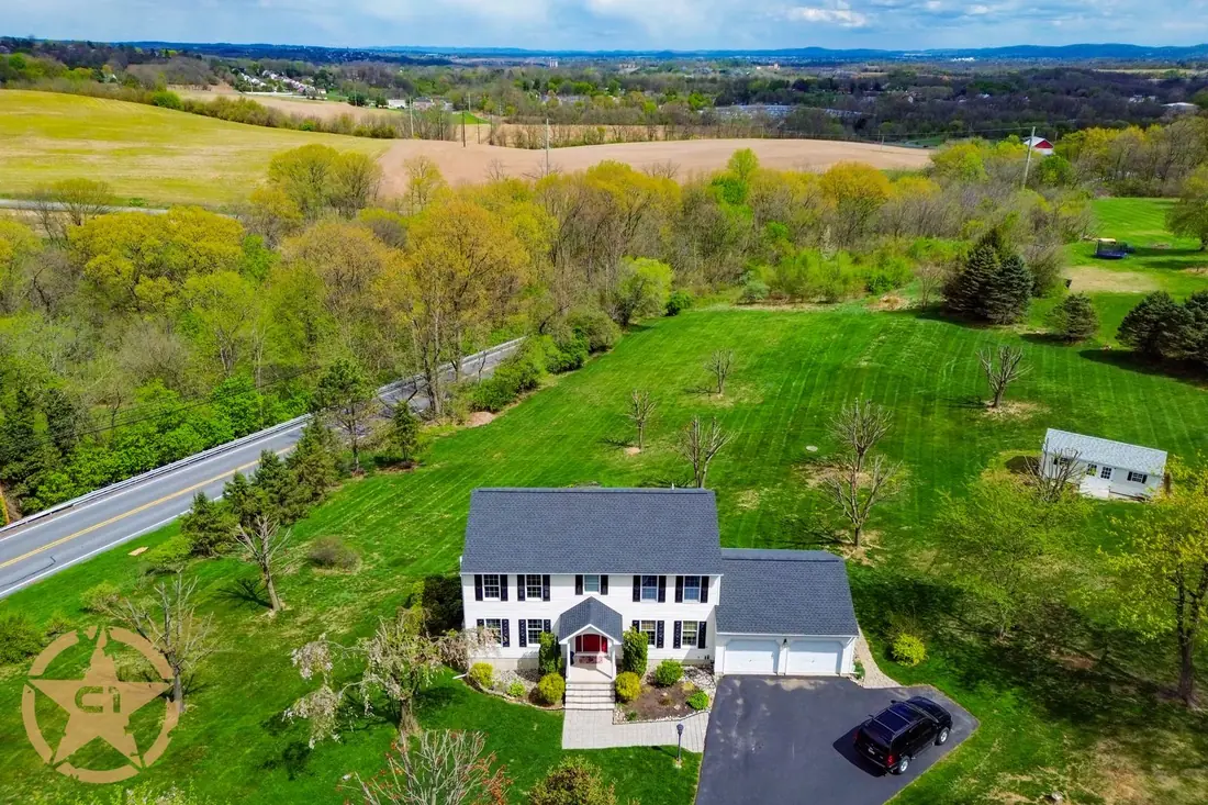 Aerial view of a completed roof replacement on a two story colonial